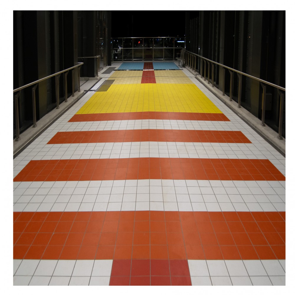 colourful-tiles-inspired-by-20th-century-train-tickets-envelop-hoppers-crossing-walkway