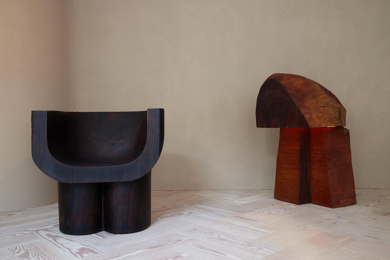 Mamut, 2021 Armchair (left), in hand-carved, charred almendron; Maxed Lamp, 2022, (right) in hand-carved mahogany