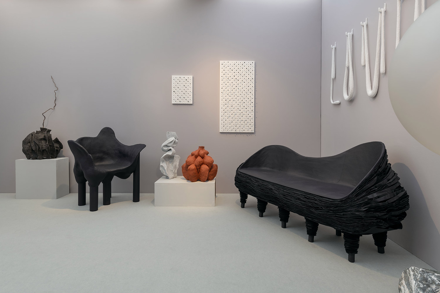 Sofa by Vadim Kibardin, sculptures by Voznicki and wall art by Jonne Stout