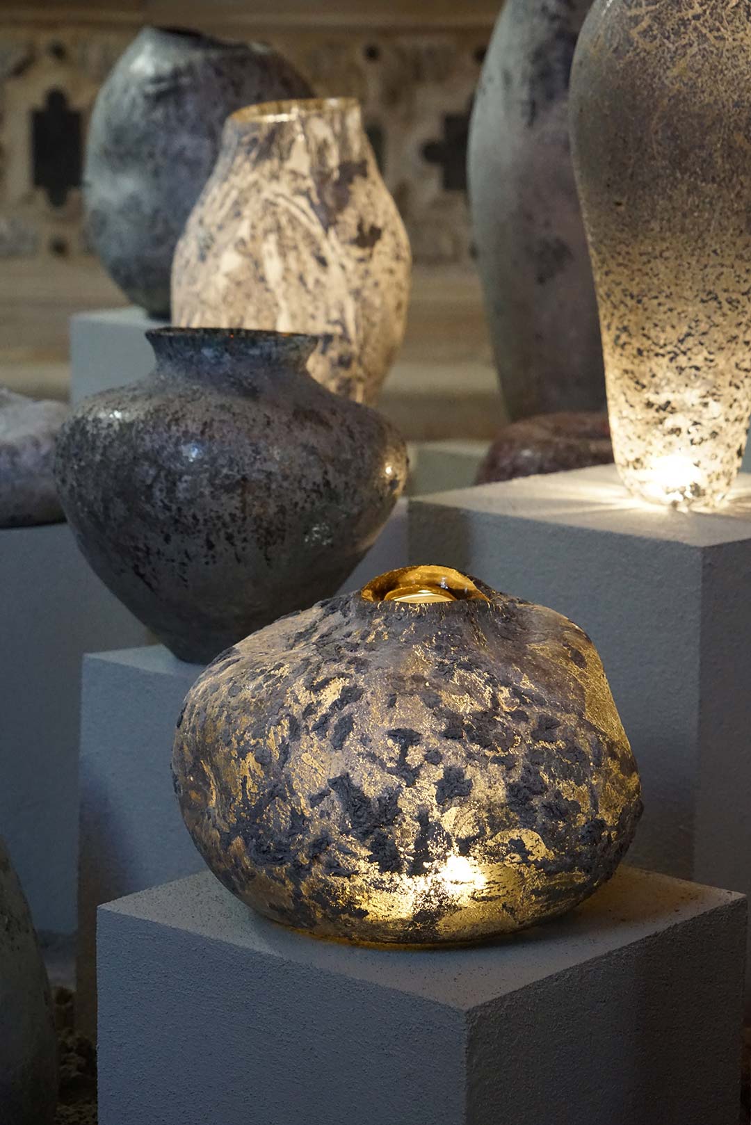 The sculptural designs experiment with integrating waste metal into glass